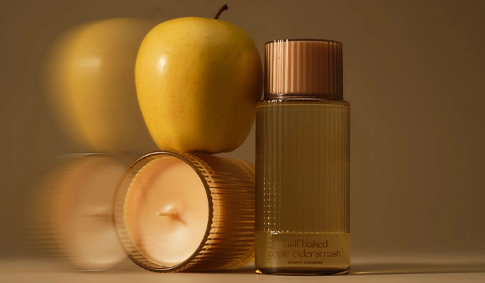 Golden apples beside an Apple Cider Smash candle