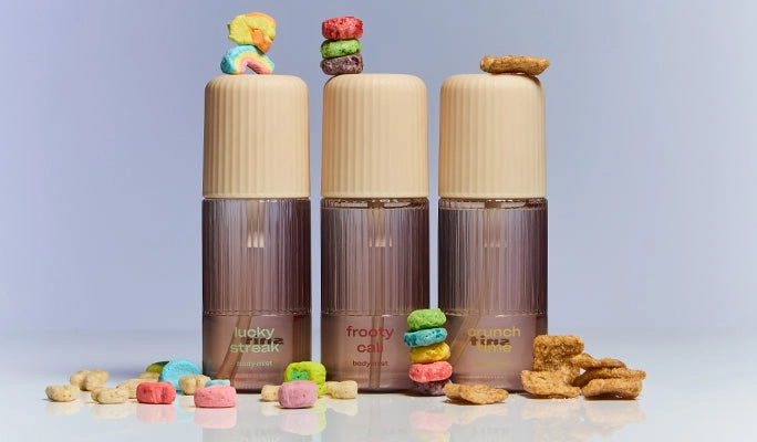 Body mist bottles stacked with cereal pieces