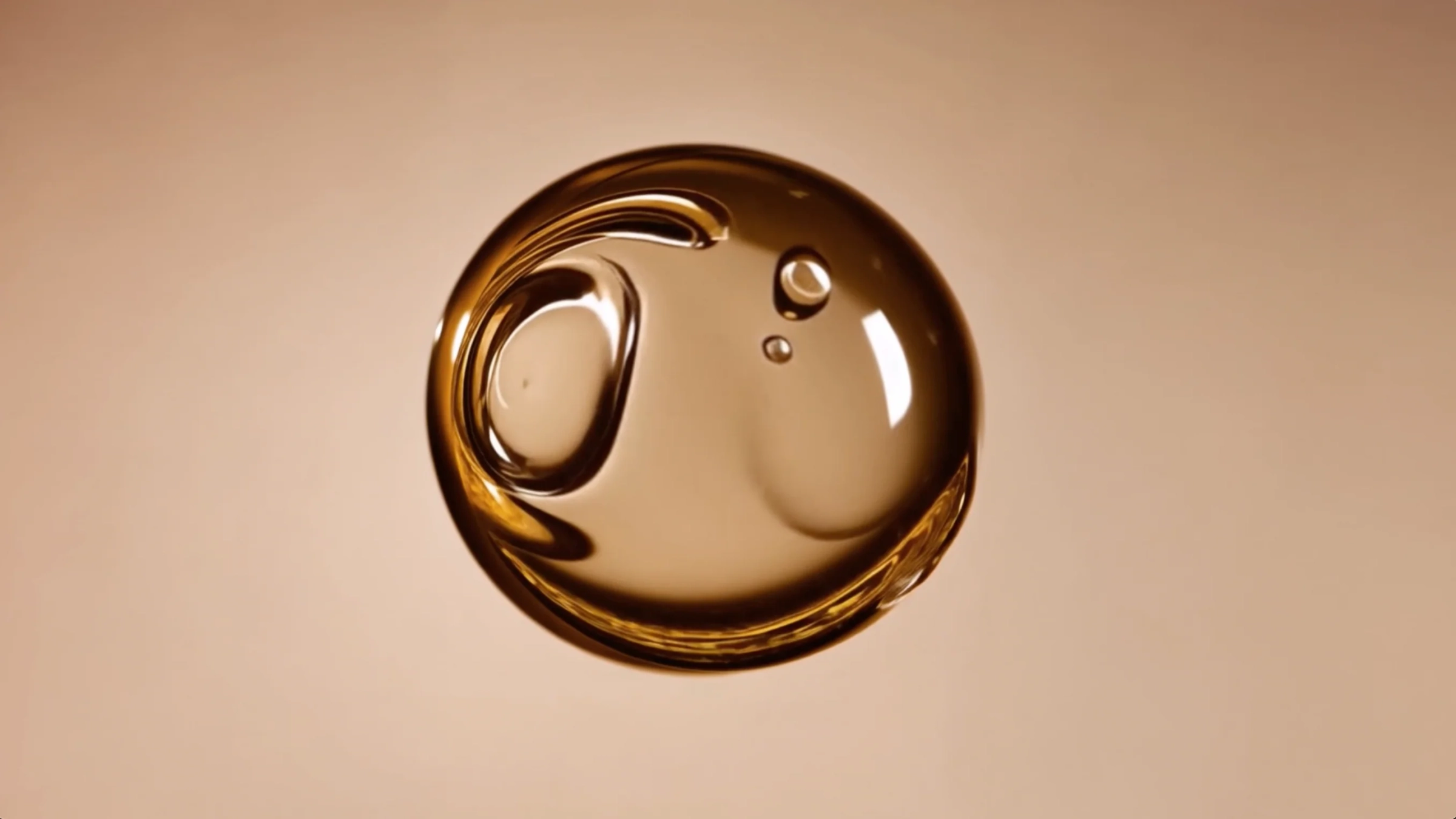 A droplet of amber fragrance oil seen from above